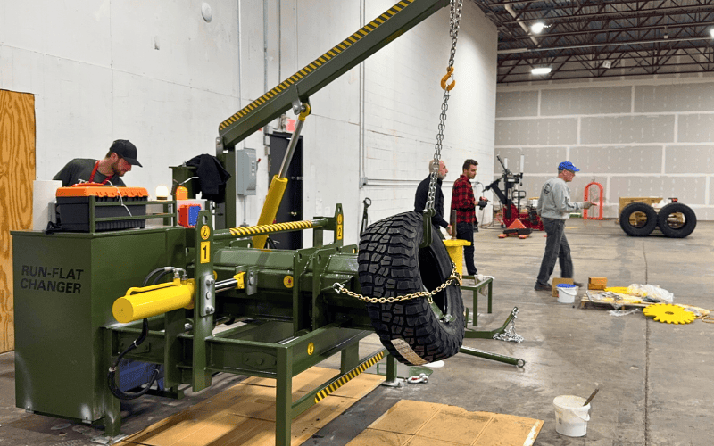 GMR-023 Workshop Model — live operation with operators handling military tire assembly